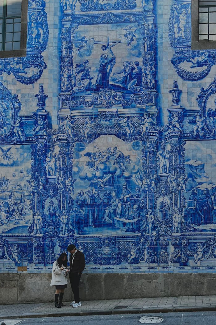 couple-admiring-azulejo-tiles-in-porto-portugal-35634381